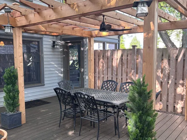 Timber pergola over a backyard deck dining area