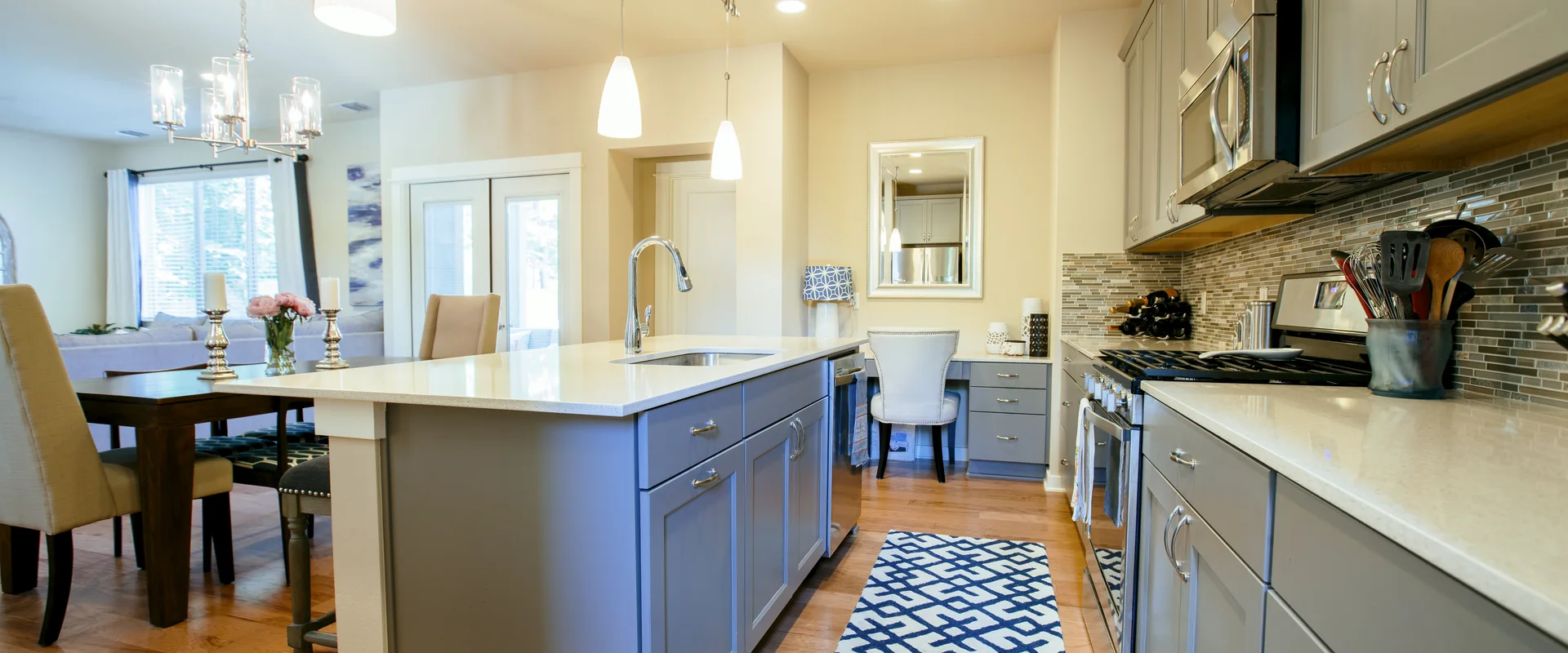 Modern remodeled kitchen with island, pendant lighting and open dining area