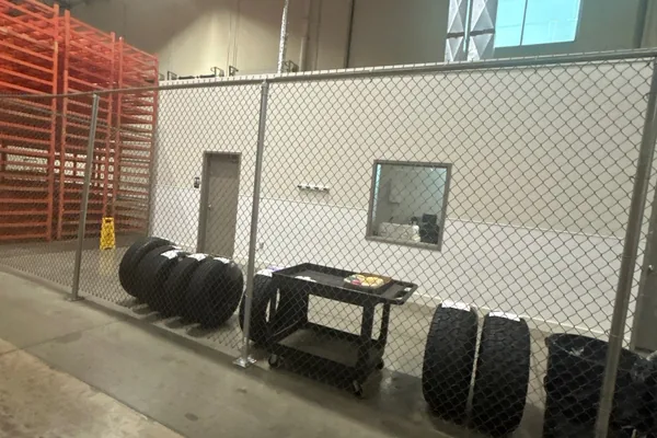 Industrial warehouse interior with security fencing