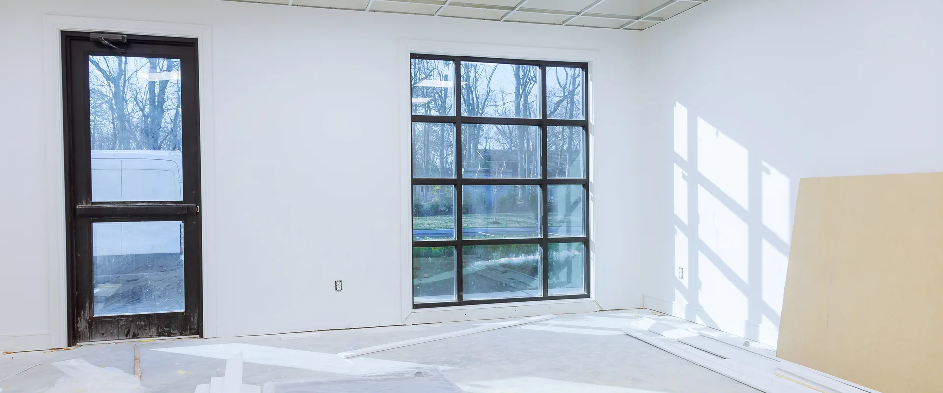 Commercial interior under renovation with unfinished ceiling and construction materials