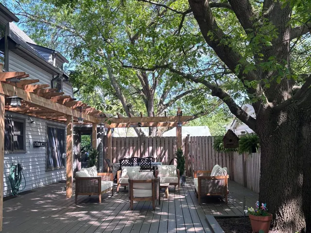 Backyard deck with pergola and mature shade trees