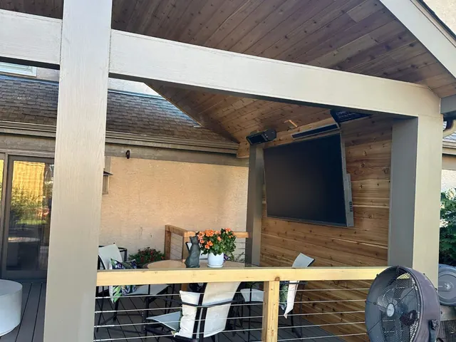 Covered deck with railing, wood ceiling and outdoor seating